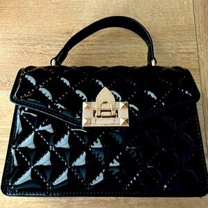 Black with gold accents Olivia Miller bag.